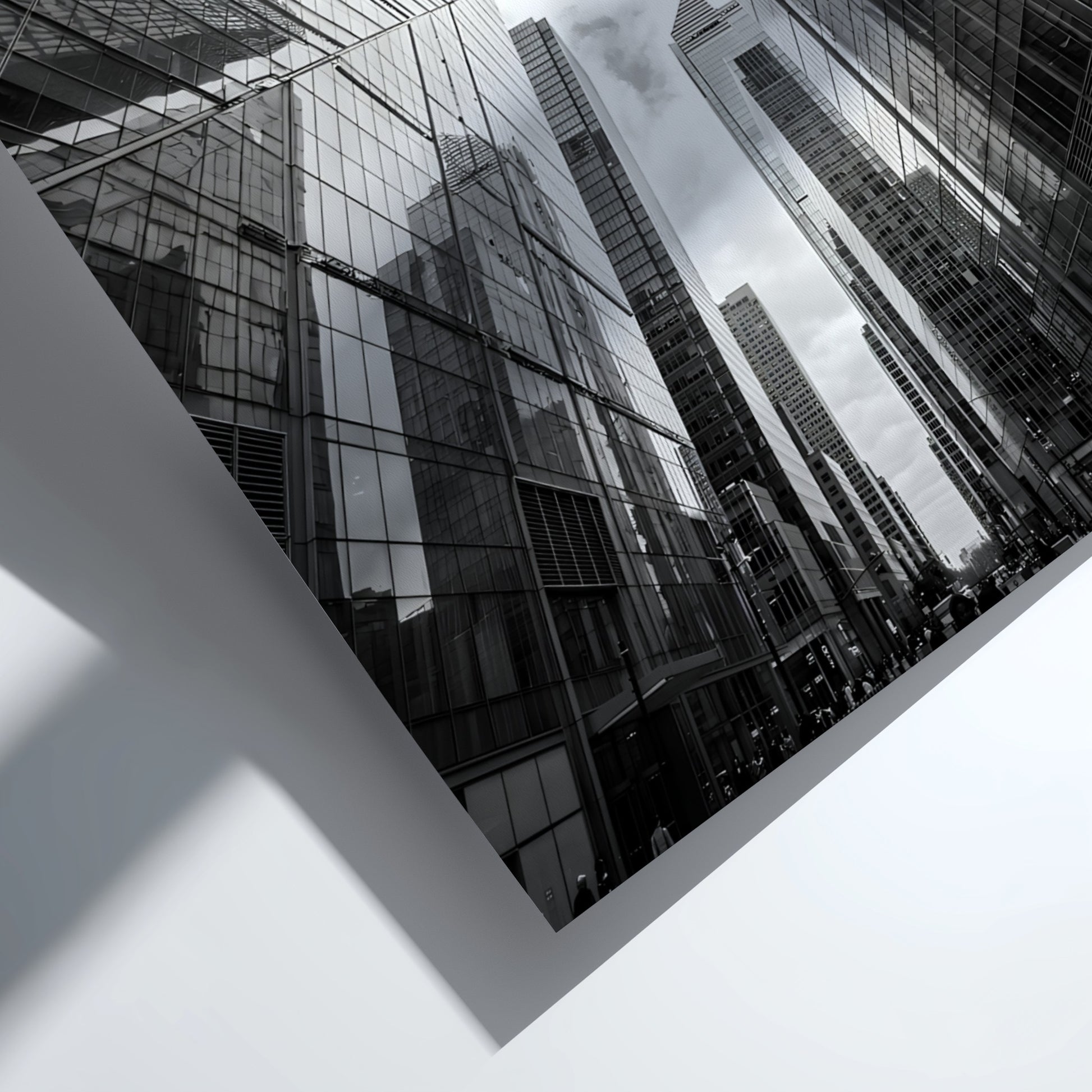 Wall decor featuring black-and-white urban photography of skyscrapers converging with reflective glass