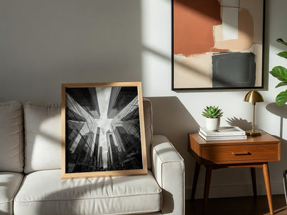 Wall decor featuring black-and-white urban photography of skyscrapers converging with reflective glass