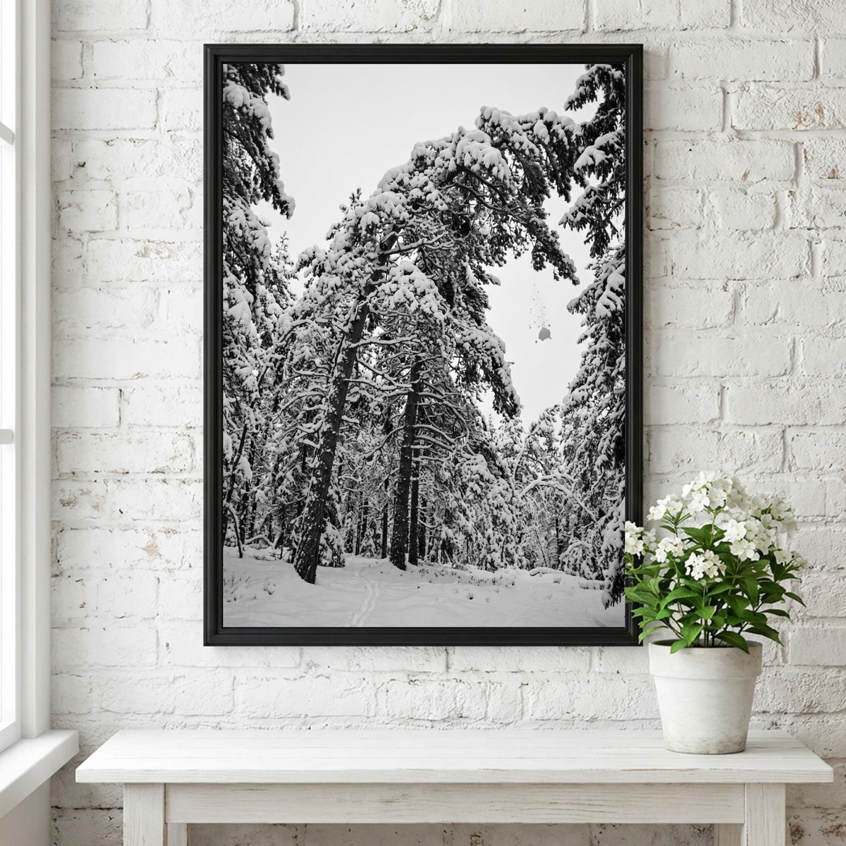 Poster of snow falling from pine trees in monochrome palette with snowy forest landscape