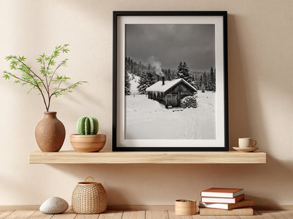 Wall decor showing snowy cabin with smoking chimney in grayscale winter forest landscape