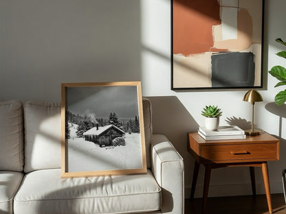 Wall decor showing snowy cabin with smoking chimney in grayscale winter forest landscape