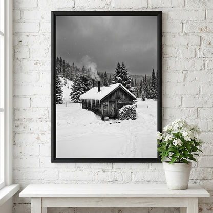 Wall decor showing snowy cabin with smoking chimney in grayscale winter forest landscape