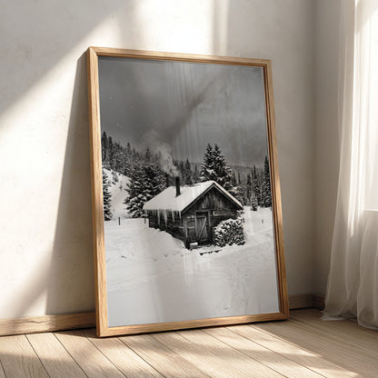 Wall decor showing snowy cabin with smoking chimney in grayscale winter forest landscape