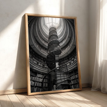black and white poster featuring spiral staircase inside circular library with iron railings and skylight