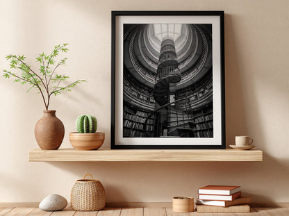 black and white poster featuring spiral staircase inside circular library with iron railings and skylight