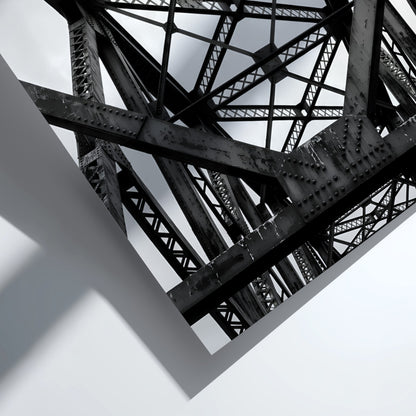 Black and white wall decor featuring steel bridge trusses with geometric patterns and strong shadows