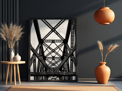Black and white wall decor featuring steel bridge trusses with geometric patterns and strong shadows