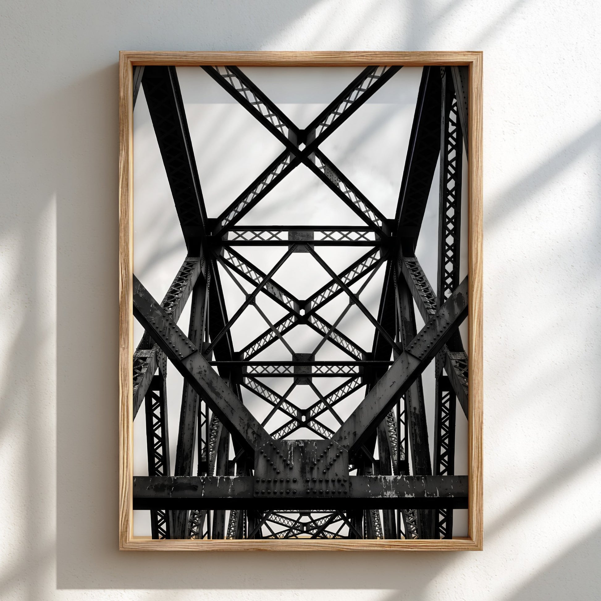 Black and white wall decor featuring steel bridge trusses with geometric patterns and strong shadows