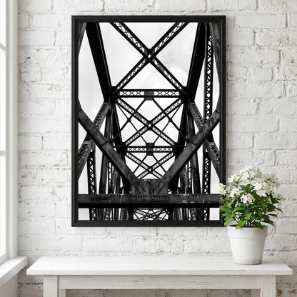 Black and white wall decor featuring steel bridge trusses with geometric patterns and strong shadows