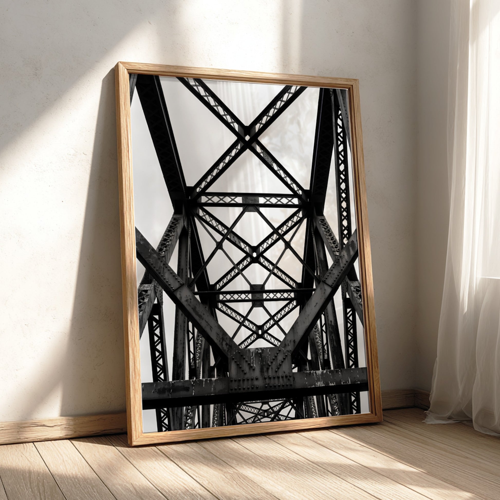 Black and white wall decor featuring steel bridge trusses with geometric patterns and strong shadows