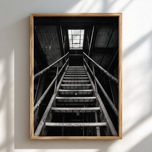Black and white poster of steel staircase in industrial building with geometric lines and skylight