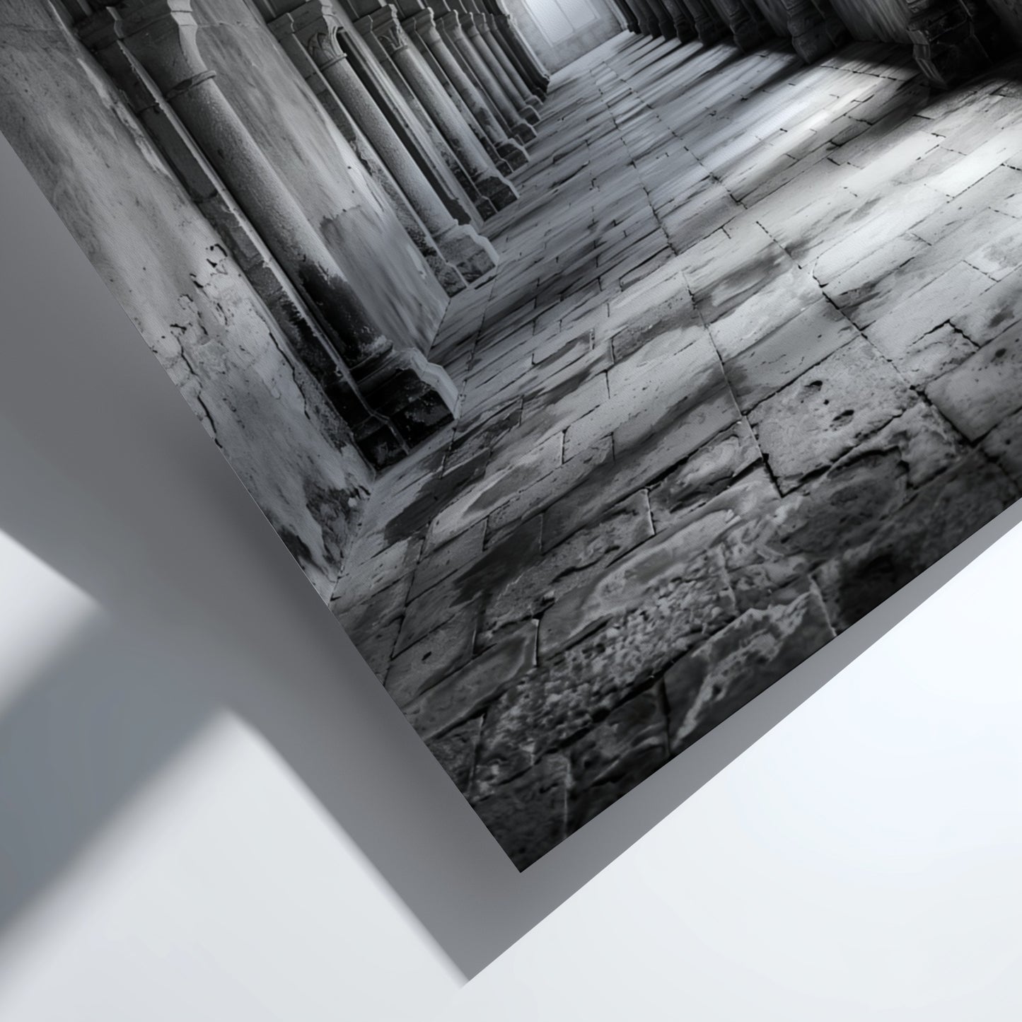 Black and white wall decor of stone corridor with rounded arches and textured stone floor