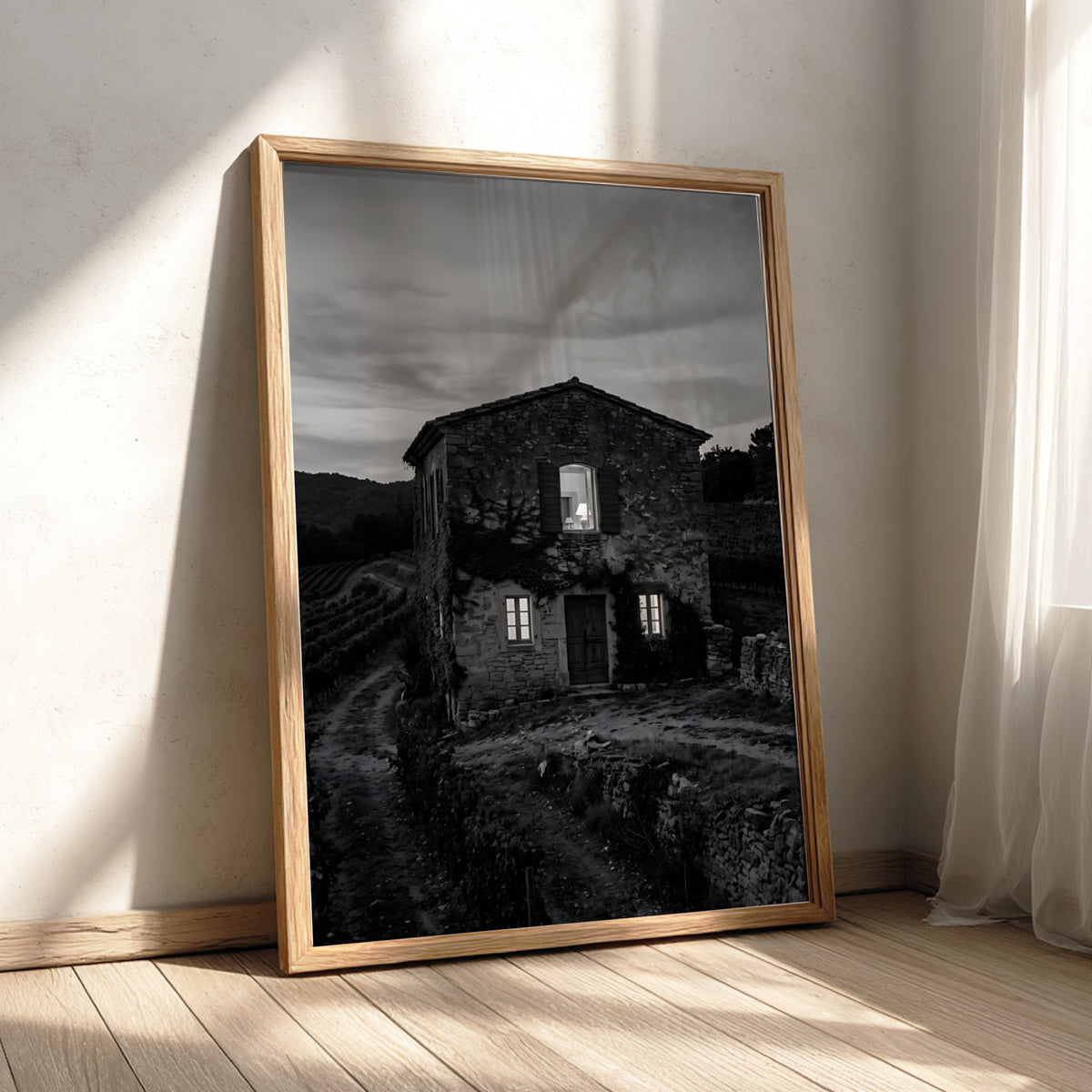 Black and white wall decor featuring a stone vineyard estate house at dusk with shutters and winding path