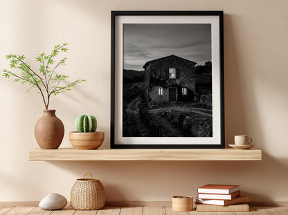 Black and white wall decor featuring a stone vineyard estate house at dusk with shutters and winding path