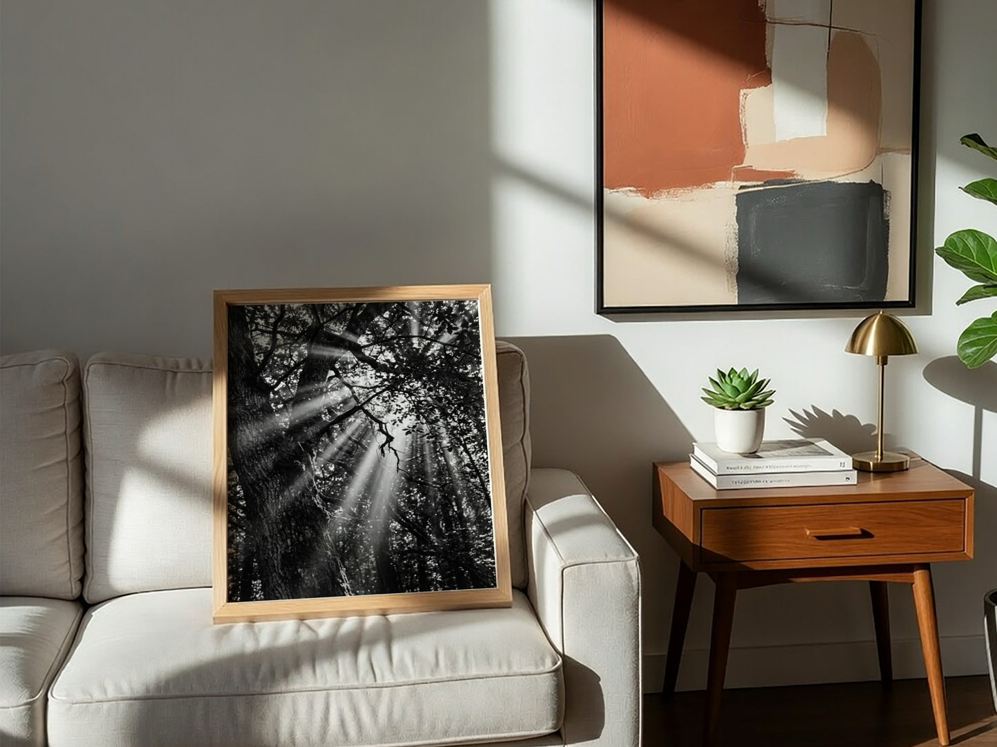 Black and white wall decor showing sunlight beams breaking through dense forest trees and branches