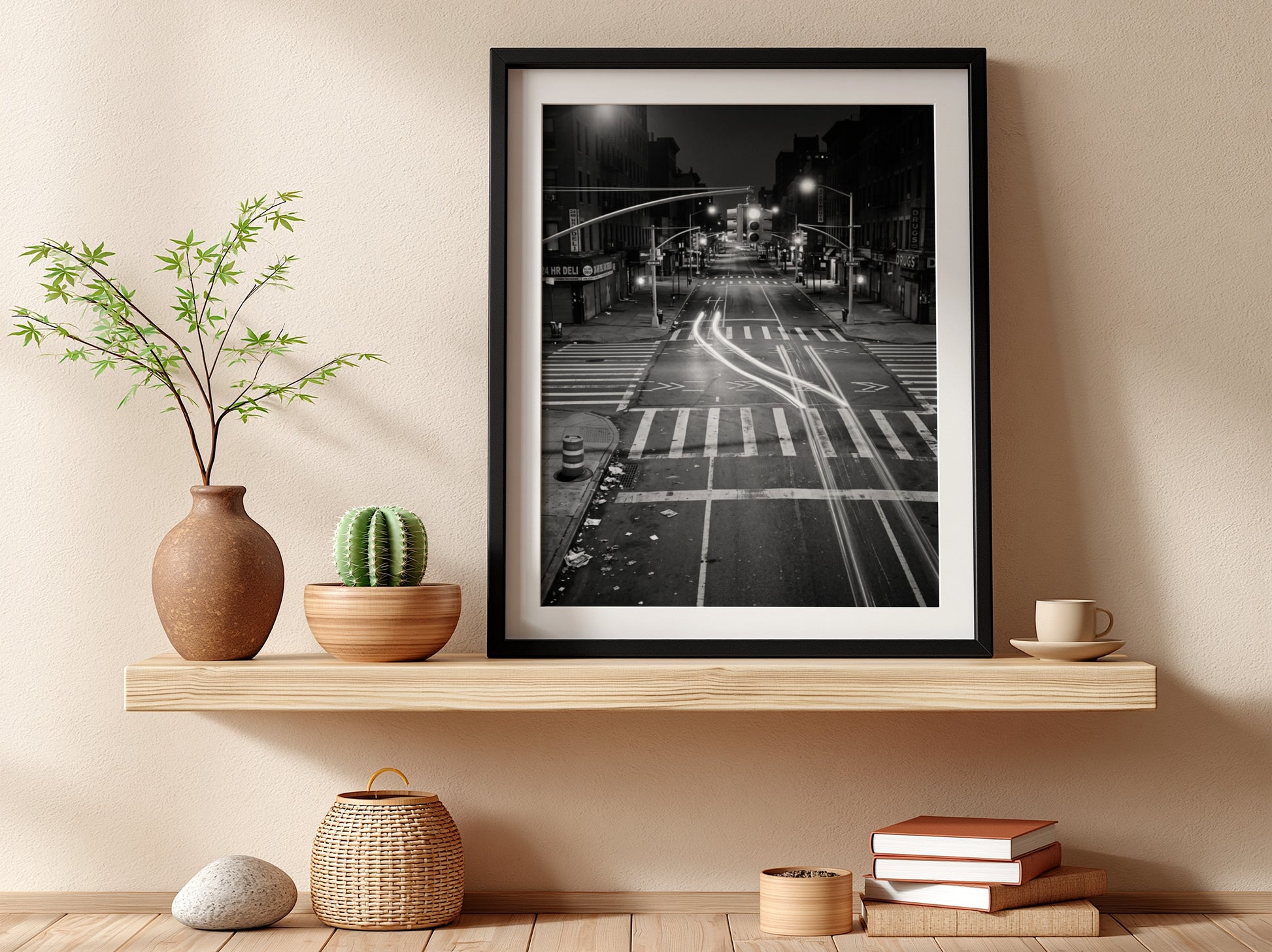 black and white wall decor of taxi passing empty city intersection with light trails at night
