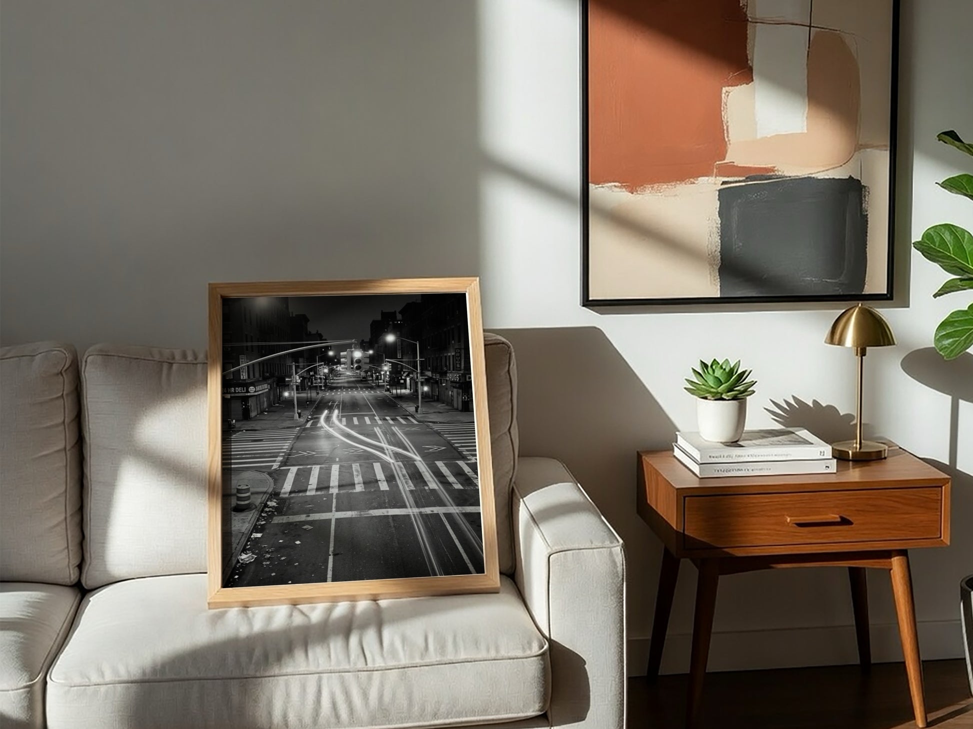 black and white wall decor of taxi passing empty city intersection with light trails at night