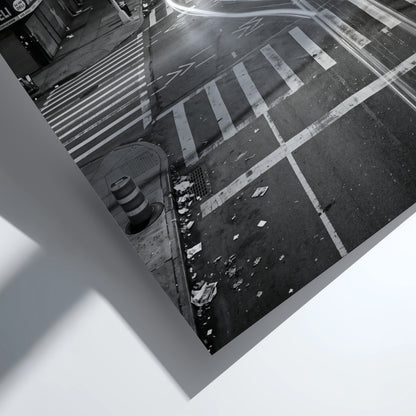 black and white wall decor of taxi passing empty city intersection with light trails at night
