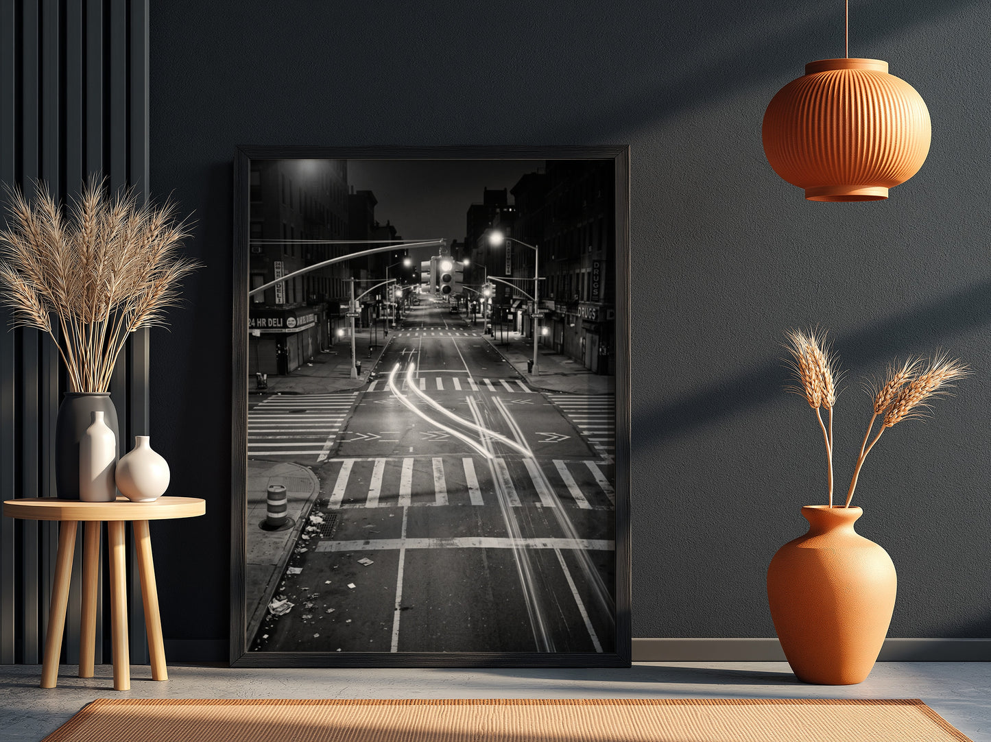 black and white wall decor of taxi passing empty city intersection with light trails at night