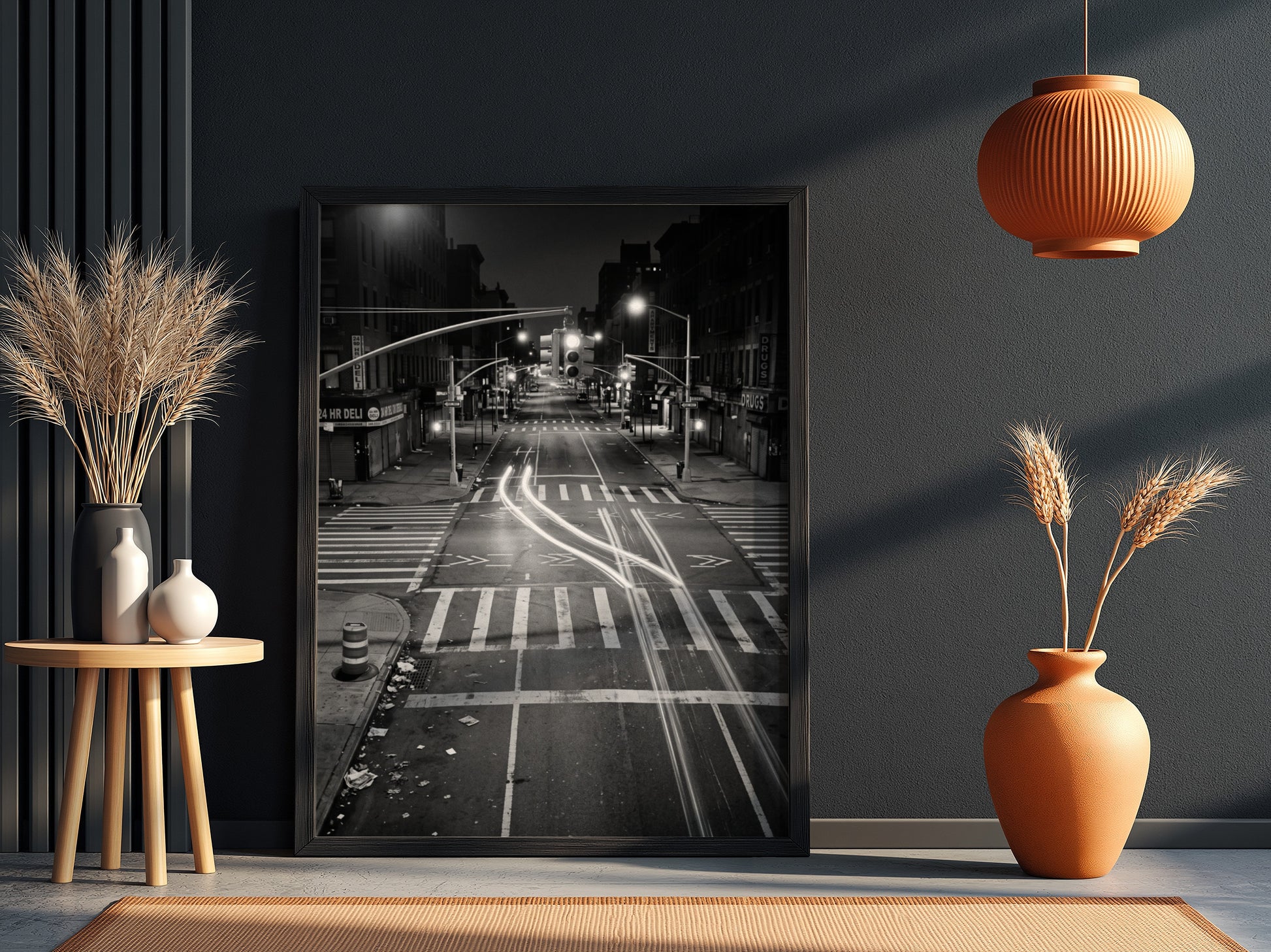 black and white wall decor of taxi passing empty city intersection with light trails at night