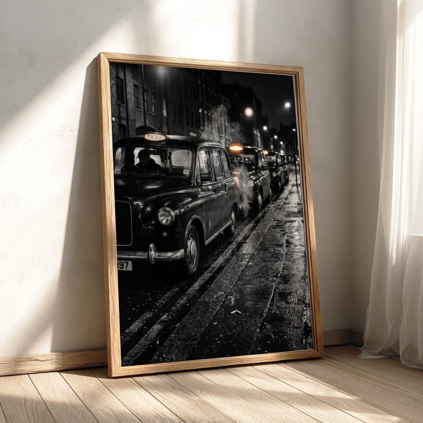 Wall decor showing black and white photo of London black cabs lined up at night on wet street