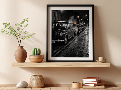 Wall decor showing black and white photo of London black cabs lined up at night on wet street