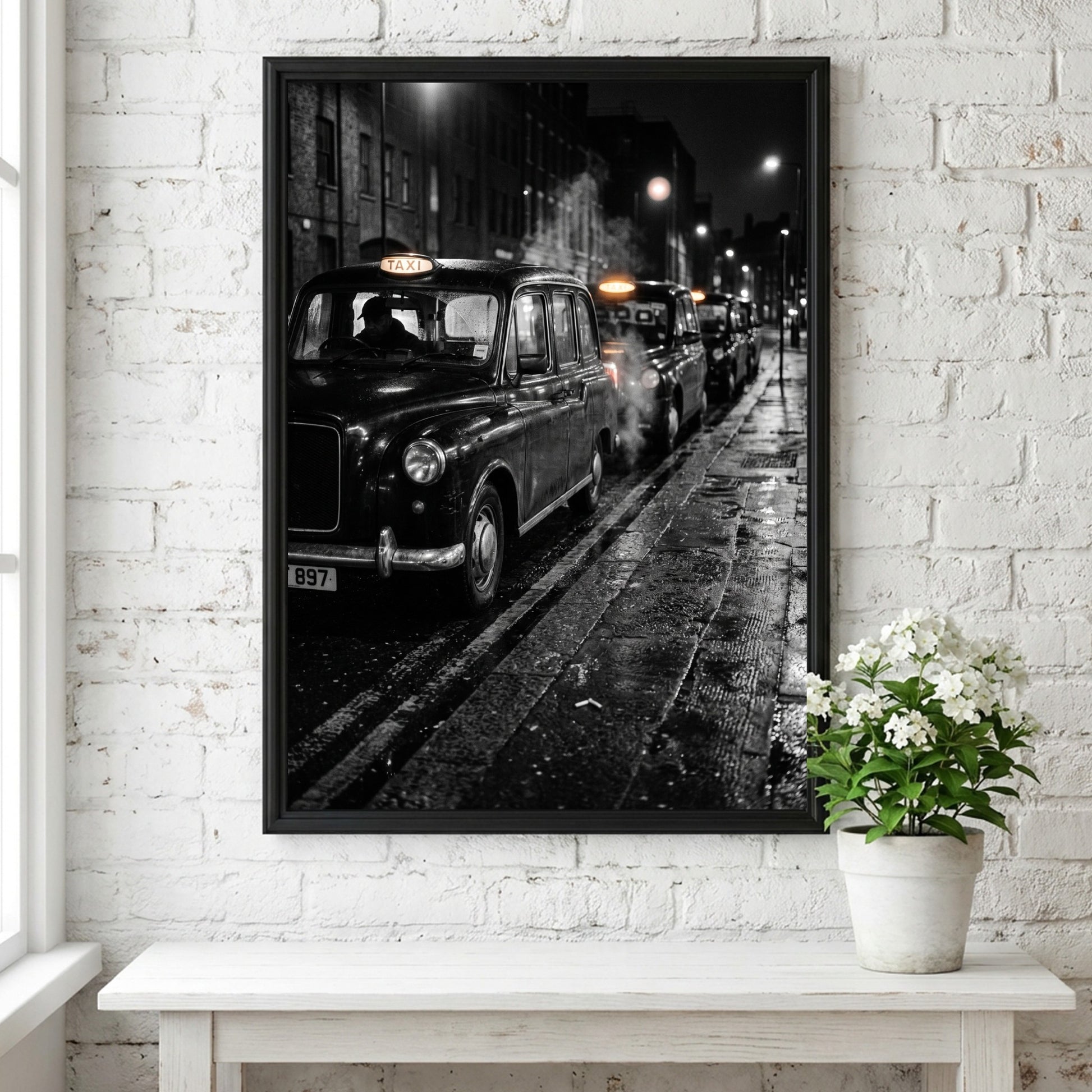 Wall decor showing black and white photo of London black cabs lined up at night on wet street
