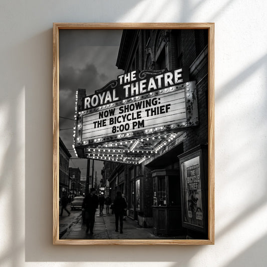 Black and white poster of Royal Theatre marquee glowing at night with vintage street scene