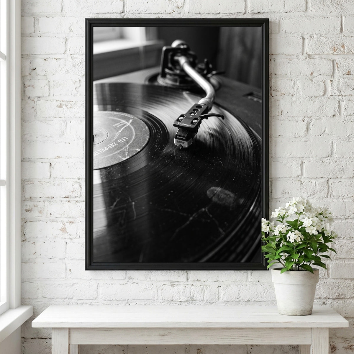 photographic wall decor showing black and white close-up of turntable needle on vinyl record