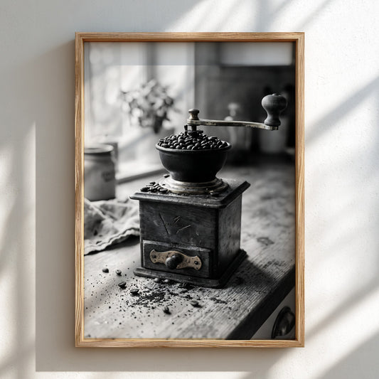 Vintage coffee grinder poster in black and white with coffee beans on wooden surface