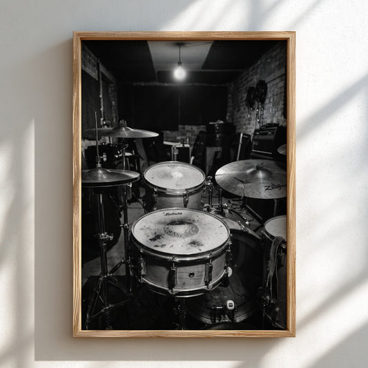 Vintage drum kit wall decor black and white photo showing worn drums and cymbals in rehearsal room