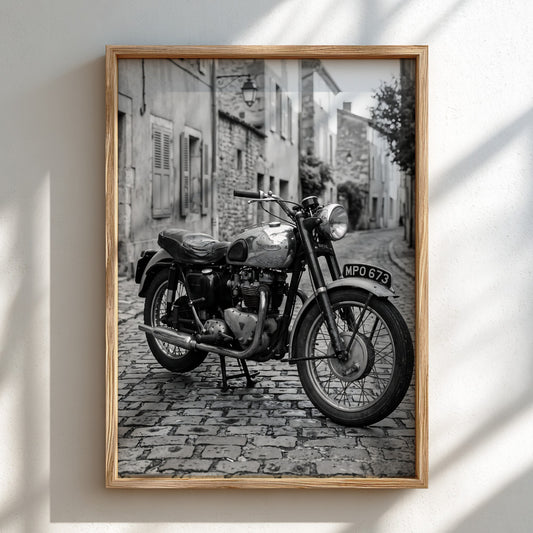 Vintage motorcycle wall poster in black and white featuring classic bike on cobblestone street