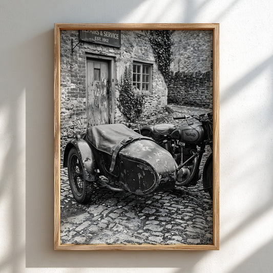Black and white vintage motorcycle with sidecar on cobblestone street rustic brick building