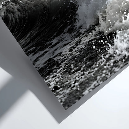 Black and white poster of a breaking wave on rocky beach with splashing water and moody sky