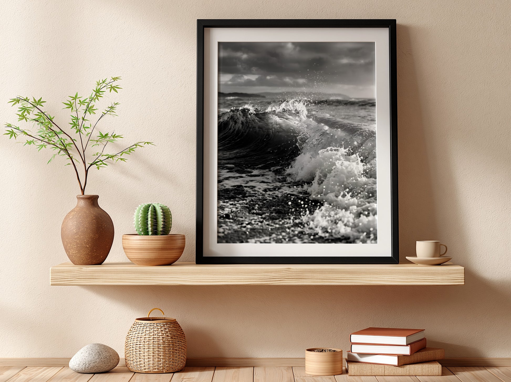 Black and white poster of a breaking wave on rocky beach with splashing water and moody sky