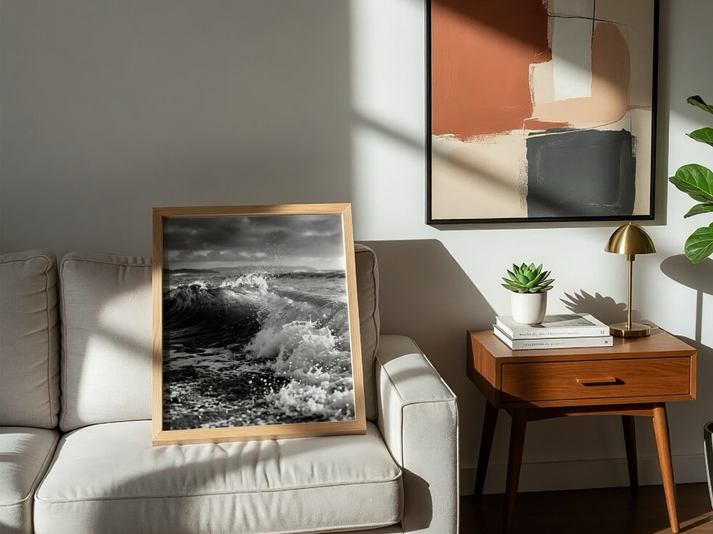 Black and white poster of a breaking wave on rocky beach with splashing water and moody sky