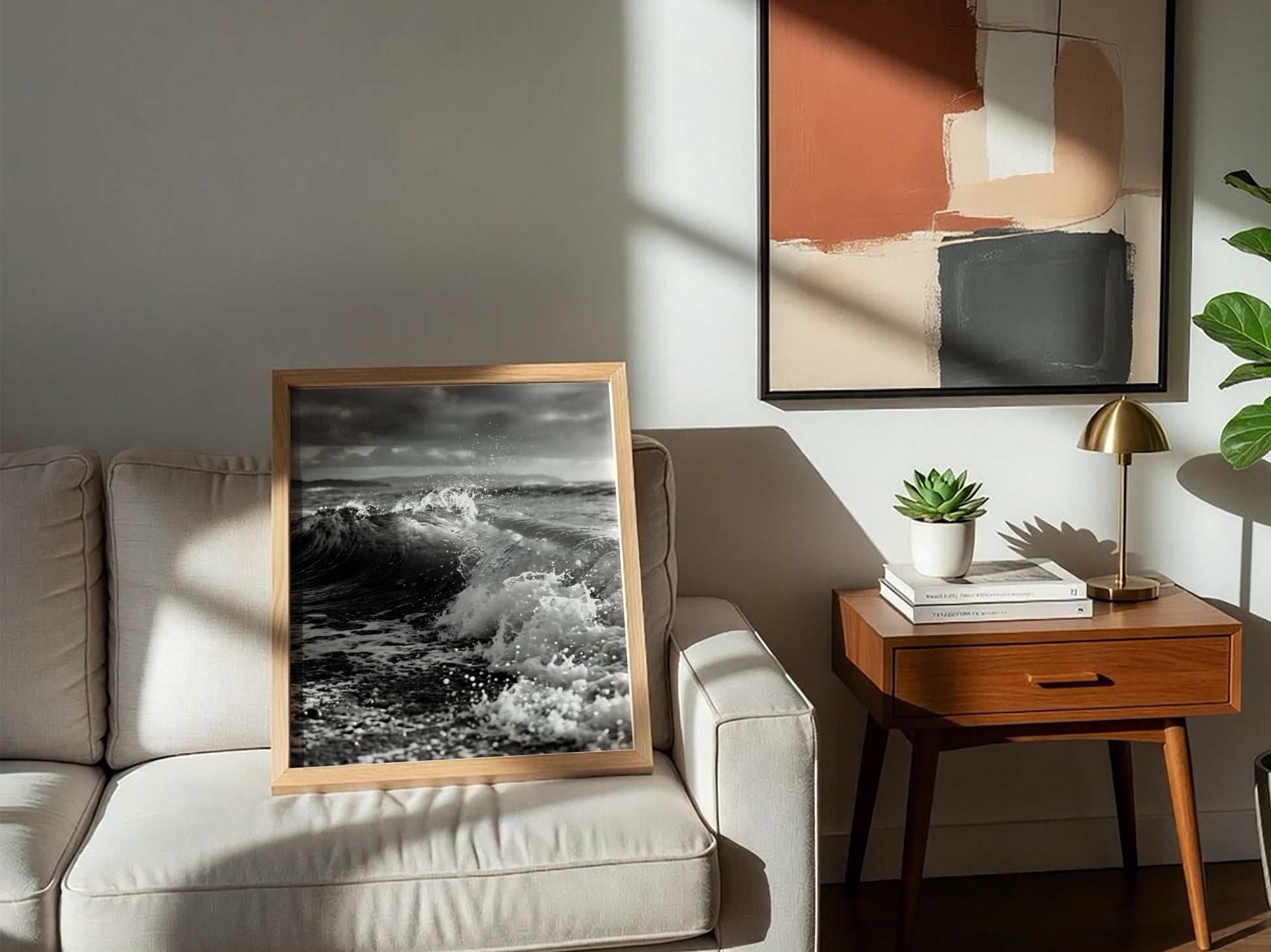 Black and white poster of a breaking wave on rocky beach with splashing water and moody sky