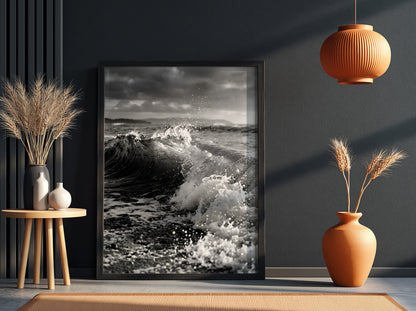 Black and white poster of a breaking wave on rocky beach with splashing water and moody sky