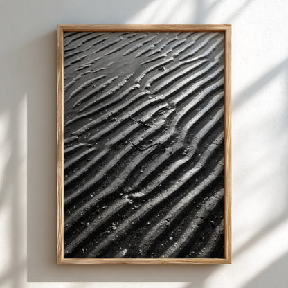 Poster of wet sand at low tide with black and gray rippled patterns and textured surface