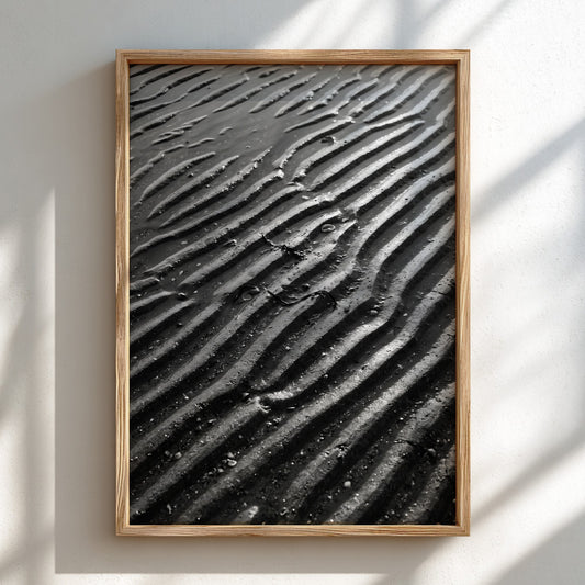 Poster of wet sand at low tide with black and gray rippled patterns and textured surface