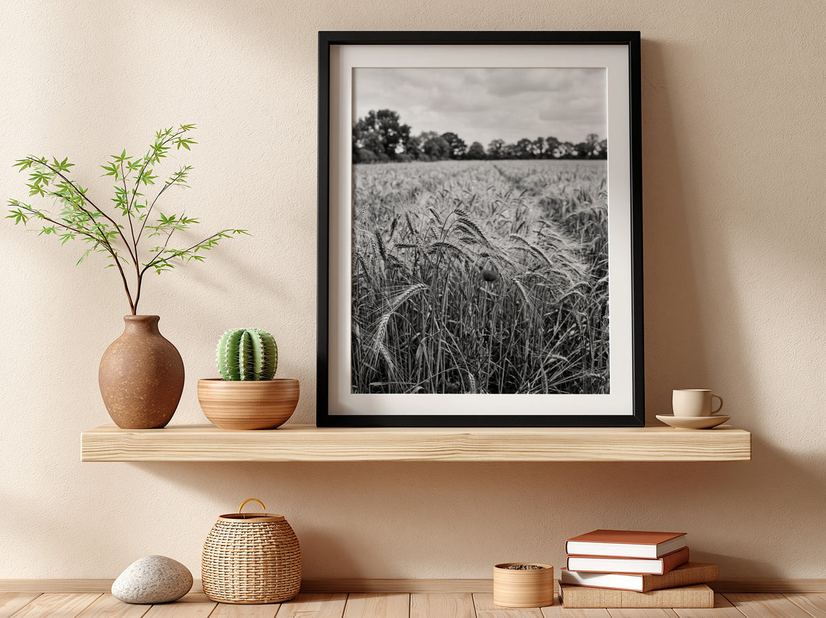 Black and white poster of wheat field with tall stalks swaying and trees in background