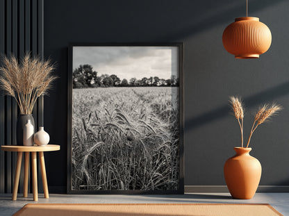 Black and white poster of wheat field with tall stalks swaying and trees in background