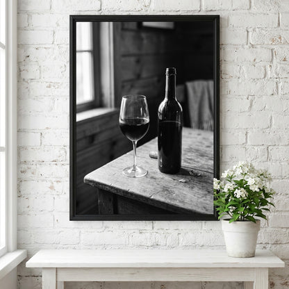 Wall decor poster showing black and white wine bottle and glass on rustic wooden table with soft window light