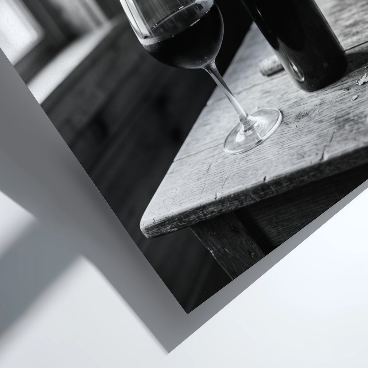 Wall decor poster showing black and white wine bottle and glass on rustic wooden table with soft window light
