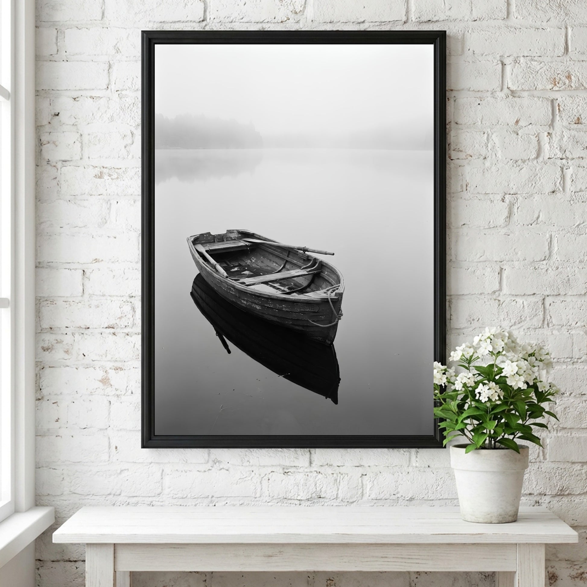 Black and white wall decor featuring a wooden rowing boat floating on calm water with soft reflections