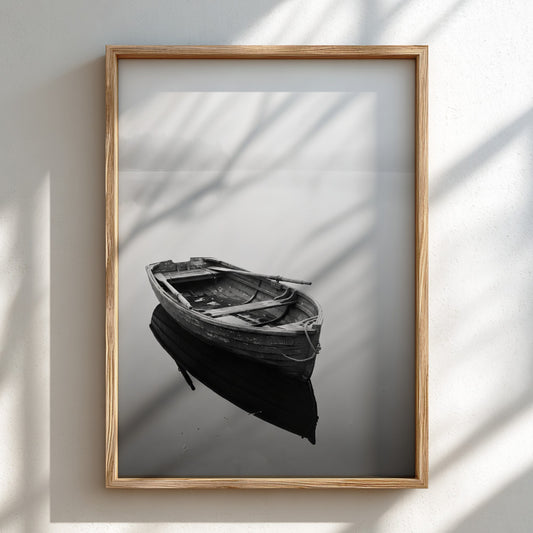 Black and white wall decor featuring a wooden rowing boat floating on calm water with soft reflections